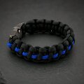 A close-up view of the black and blue woven paracord bracelet featuring a dark gunmetal buckle.