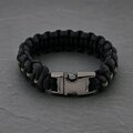 The paracord bracelet shown with its gunmetal side-release buckle fastened.