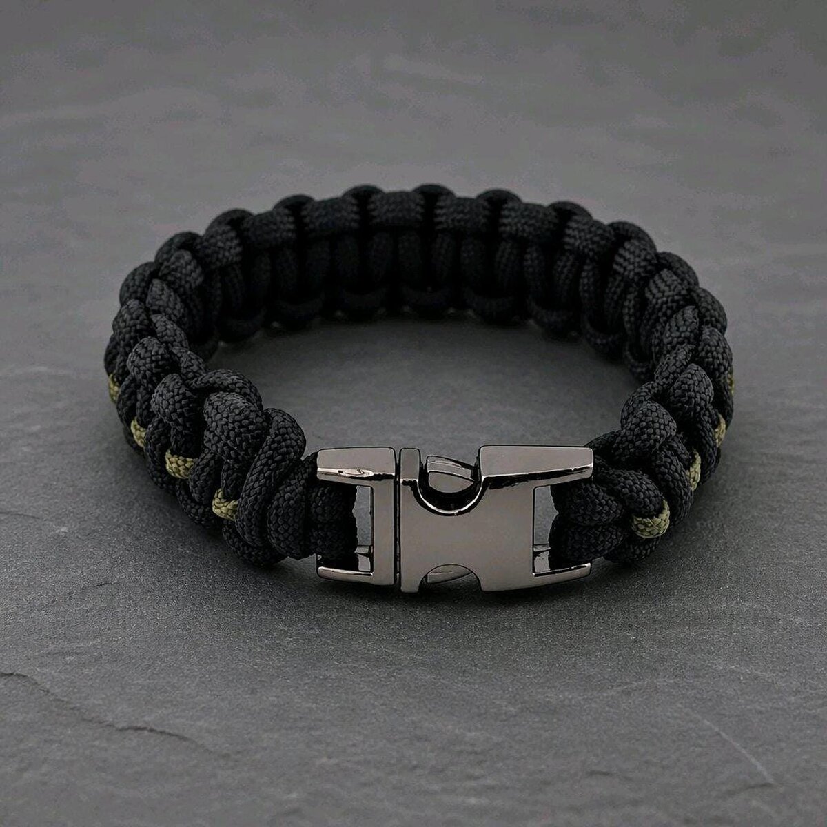 The paracord bracelet shown with its gunmetal side-release buckle fastened.